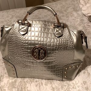 Shiny silver purse with gold accents
